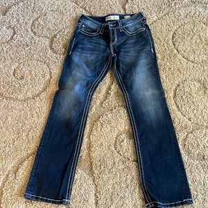 Jeans. Size is a 29. And dark washed. And flared.